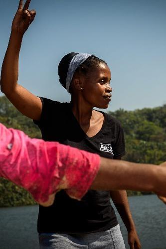 A South Africa anti-mining activist and environmentalist raising her hands.